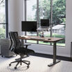 Electric Standing Desk 60x30 Walnut in lowered position at home